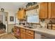 This kitchen features wooden cabinets, stainless steel sinks, and light-colored countertops at 2608 E 500 N, Whiteland, IN 46184