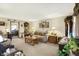 Spacious living room with a cozy sofa, warm lighting, and a glimpse into the adjacent dining area at 2608 E 500 N, Whiteland, IN 46184