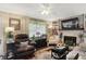 Inviting living room with a cozy fireplace, ceiling fan, and comfortable seating at 2608 E 500 N, Whiteland, IN 46184