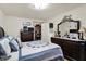 Comfortable main bedroom with a dark wood dresser, TV, wardrobe, a patterned quilt and light walls at 2608 E 500 N, Whiteland, IN 46184