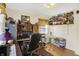 Home office with wood floors, natural light, large rug, collection of toys and ironing board at 2608 E 500 N, Whiteland, IN 46184