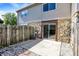 Backyard featuring a stone foundation, sliding glass door, concrete patio, and a wooden fence at 2642 Country Estates Dr, Indianapolis, IN 46227