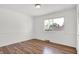 Bright bedroom featuring wood-look flooring and a large window with views of the outdoors at 2642 Country Estates Dr, Indianapolis, IN 46227