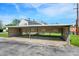 Carport with parking spots, providing covered parking for residents, and a view of the building at 2642 Country Estates Dr, Indianapolis, IN 46227