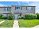 Charming townhome featuring stone accents, vinyl siding, and a well-manicured lawn at 2642 Country Estates Dr, Indianapolis, IN 46227