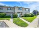 View of the townhome exterior featuring a well manicured lawn and concrete walkway at 2642 Country Estates Dr, Indianapolis, IN 46227