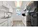 Bright kitchen with white cabinets, stainless steel sink, and view to the front lawn at 2642 Country Estates Dr, Indianapolis, IN 46227