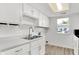 Bright and clean kitchen offers white cabinets and stainless steel sink at 2642 Country Estates Dr, Indianapolis, IN 46227