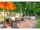 Cozy backyard featuring a brick patio with comfortable seating around a fire pit at 3312 W 42Nd St, Indianapolis, IN 46228