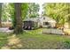 Spacious backyard with a brick patio, outdoor seating, and lush greenery at 3312 W 42Nd St, Indianapolis, IN 46228