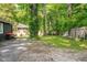 Spacious backyard featuring a lush lawn, mature trees, privacy fence, and sitting area with patio furniture at 3312 W 42Nd St, Indianapolis, IN 46228