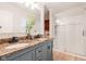 Bathroom featuring double sinks with granite counters and a glass shower at 3312 W 42Nd St, Indianapolis, IN 46228