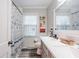 Bathroom with dual vanity, white countertop, and a shower/tub with curtain at 3312 W 42Nd St, Indianapolis, IN 46228