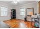 Neutral bedroom with natural light, hardwood floors and simple furnishings at 3312 W 42Nd St, Indianapolis, IN 46228
