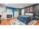 Bedroom featuring a fireplace, dark walls, and queen bed at 3312 W 42Nd St, Indianapolis, IN 46228