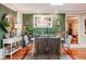 Chic dining room with green walls and a modern white table and decorative elements at 3312 W 42Nd St, Indianapolis, IN 46228