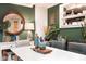 Elegant dining room displaying stylish decor, green accent walls, and a modern white table at 3312 W 42Nd St, Indianapolis, IN 46228