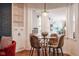 A cozy dining area with hardwood floors, a modern table and stylish chairs, filled with natural light at 3312 W 42Nd St, Indianapolis, IN 46228