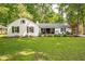 Charming one-story home featuring a well manicured lawn and a beautiful white painted brick exterior at 3312 W 42Nd St, Indianapolis, IN 46228