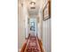 A long hallway with hardwood floors and white paneling, adorned with artwork, creating a classic, inviting space at 3312 W 42Nd St, Indianapolis, IN 46228