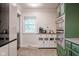 A kitchen with white cabinets, stainless steel appliances, and a wood-topped island, offering modern functionality at 3312 W 42Nd St, Indianapolis, IN 46228