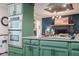 A kitchen featuring green cabinets, granite countertops, and stainless steel appliances for a modern, functional space at 3312 W 42Nd St, Indianapolis, IN 46228