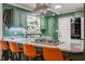 A kitchen featuring green cabinets, a granite countertop island with seating, and modern stainless steel appliances at 3312 W 42Nd St, Indianapolis, IN 46228
