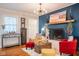 Cozy living room featuring a fireplace, hardwood floors, stylish furniture, and charming decor at 3312 W 42Nd St, Indianapolis, IN 46228