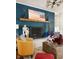 Living room features painted brick wall, fireplace, hardwood floors, and stylish decor at 3312 W 42Nd St, Indianapolis, IN 46228