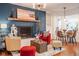 Bright living room with hardwood floors, fireplace, comfortable seating, and an open layout to the dining area at 3312 W 42Nd St, Indianapolis, IN 46228