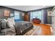 A well-lit bedroom with hardwood floors, large windows, and elegant furniture, offering a serene, comfortable retreat at 3312 W 42Nd St, Indianapolis, IN 46228