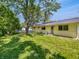 Large backyard with a mature tree and lots of grassy open space at 3344 Southwest Dr, Indianapolis, IN 46241