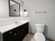 Well-lit bathroom featuring a vanity with black cabinets and a white countertop, complemented by modern fixtures at 3344 Southwest Dr, Indianapolis, IN 46241