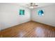 Bright bedroom featuring hardwood floors and a window providing natural light and backyard views at 3344 Southwest Dr, Indianapolis, IN 46241