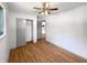 A clean bedroom with light walls, sliding closet, and ceiling fan at 3344 Southwest Dr, Indianapolis, IN 46241