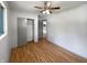 A clean bedroom with light walls, sliding closet, and ceiling fan at 3344 Southwest Dr, Indianapolis, IN 46241