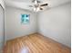 An empty bedroom with hardwood floors, a ceiling fan and a bright window at 3344 Southwest Dr, Indianapolis, IN 46241