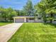 Charming single-story home featuring a well-maintained lawn, mature trees, and an attached two-car garage at 3344 Southwest Dr, Indianapolis, IN 46241