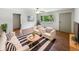 Bright living room with hardwood floors, modern furniture, and a large window offering scenic views at 3344 Southwest Dr, Indianapolis, IN 46241