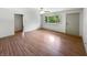 Spacious living room featuring hardwood floors, a ceiling fan, and a view of the yard through a window at 3344 Southwest Dr, Indianapolis, IN 46241
