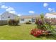Lush backyard featuring manicured lawn, vibrant rose bushes, and privacy landscaping at 3423 Summer Breeze Cir, Indianapolis, IN 46239