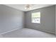 Neutral bedroom offers a ceiling fan, carpeting, and bright natural light from the window at 3423 Summer Breeze Cir, Indianapolis, IN 46239