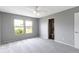 A bright bedroom with neutral gray paint, a ceiling fan, and access to an ensuite bathroom at 3423 Summer Breeze Cir, Indianapolis, IN 46239