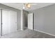 A gray bedroom with a ceiling fan, closet, and ensuite bathroom access for convenience at 3423 Summer Breeze Cir, Indianapolis, IN 46239