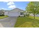 Charming single-story home featuring a well-maintained lawn and an attached two-car garage at 3423 Summer Breeze Cir, Indianapolis, IN 46239