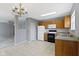 Traditional kitchen features wood cabinets, white appliances, and a chandelier at 3423 Summer Breeze Cir, Indianapolis, IN 46239