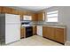 This kitchen features wood cabinets, a white refrigerator, an oven and a dishwasher at 3423 Summer Breeze Cir, Indianapolis, IN 46239