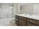 Bathroom featuring a shower with glass doors, white sink, and cabinets for storage at 3613 Lehigh Ave, Westfield, IN 46074