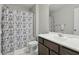 Well-lit bathroom featuring a white vanity, framed mirror, and decorative blue patterned shower curtain at 3613 Lehigh Ave, Westfield, IN 46074