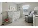 Bright and cozy Bedroom featuring a crib, soft chair, and playful decor at 3613 Lehigh Ave, Westfield, IN 46074